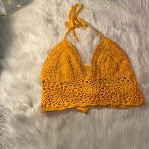 A crochet , tie up , low back crop top